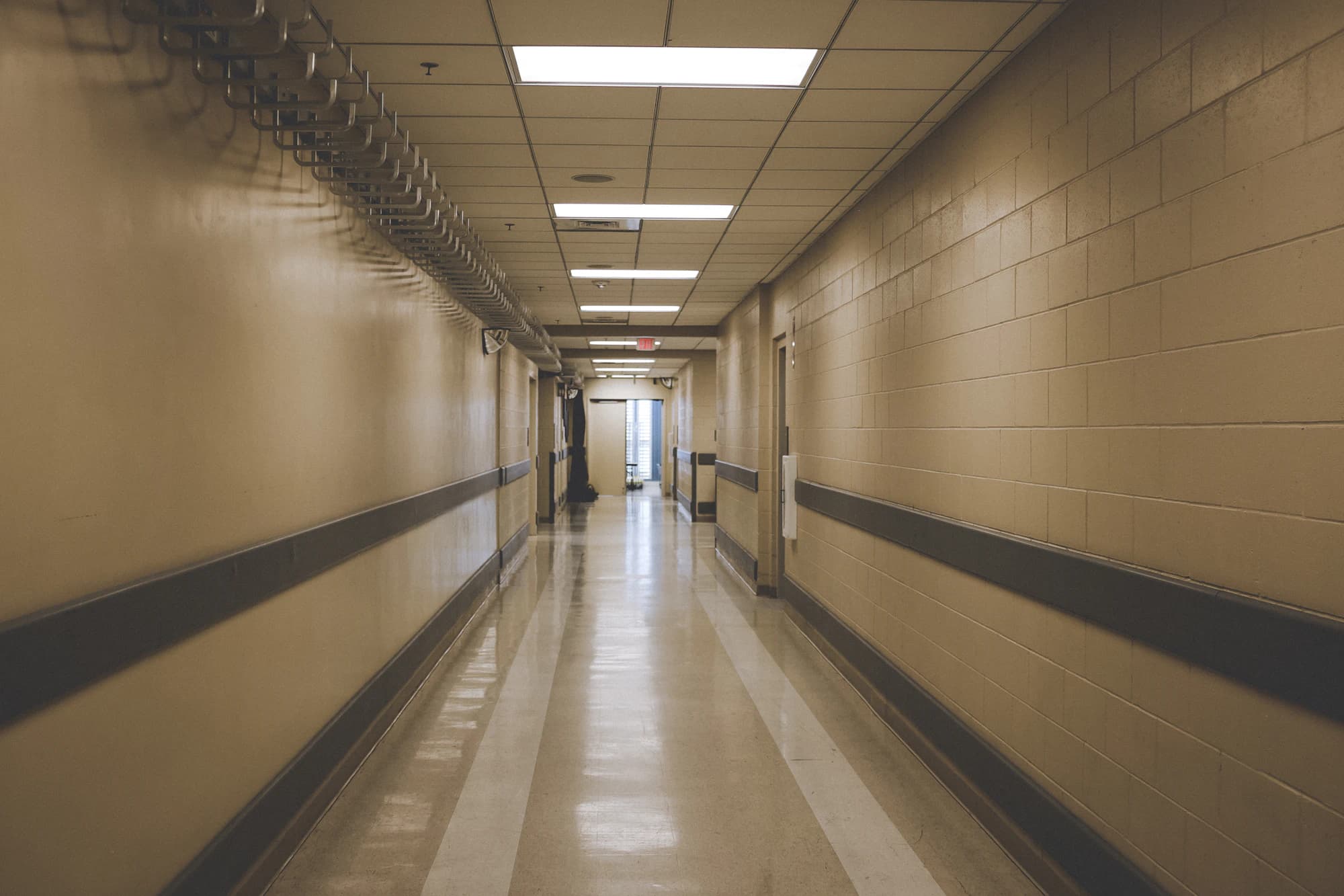 Long institutional corridor with a freshly polished floor
