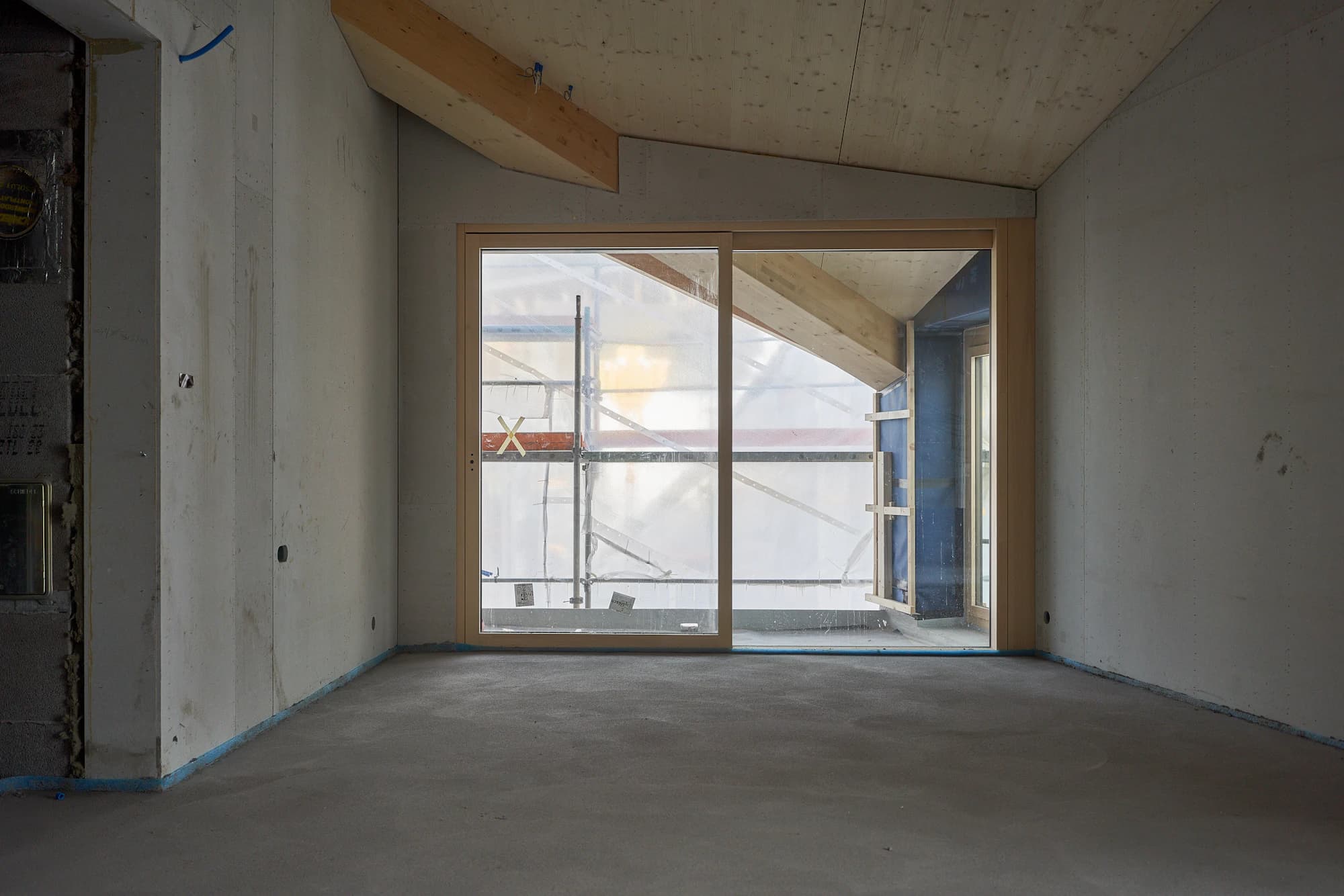Newly built room with a bare concrete floor before its first clean
